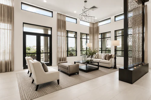 Two story clubhouse lounge with floor to ceiling windows and patio doors