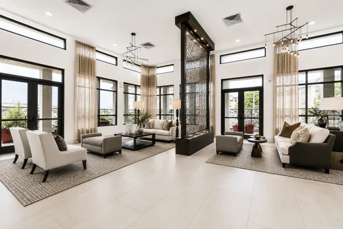 Clubhouse seating areas flanking a decorative metal screen at The Mayfair Apartments