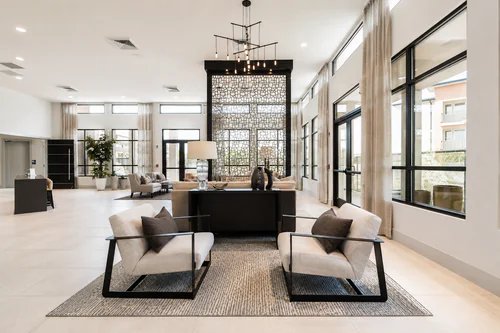 Lounge seating beneath a linear chandelier in the clubhouse at The Mayfair Apartments