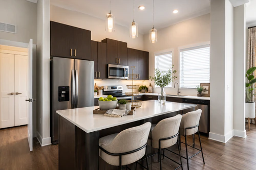 Kitchen with granite counters and stainless steel appliances at The Mayfair Apartments