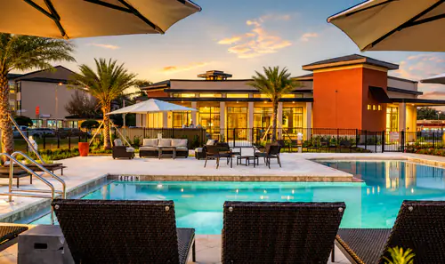 Sundeck and lounge chairs beside the pool at The Mayfair Apartments